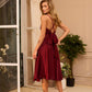 Burgundy dress with an open back and a lush skirt