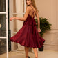 Burgundy dress with an open back and a lush skirt