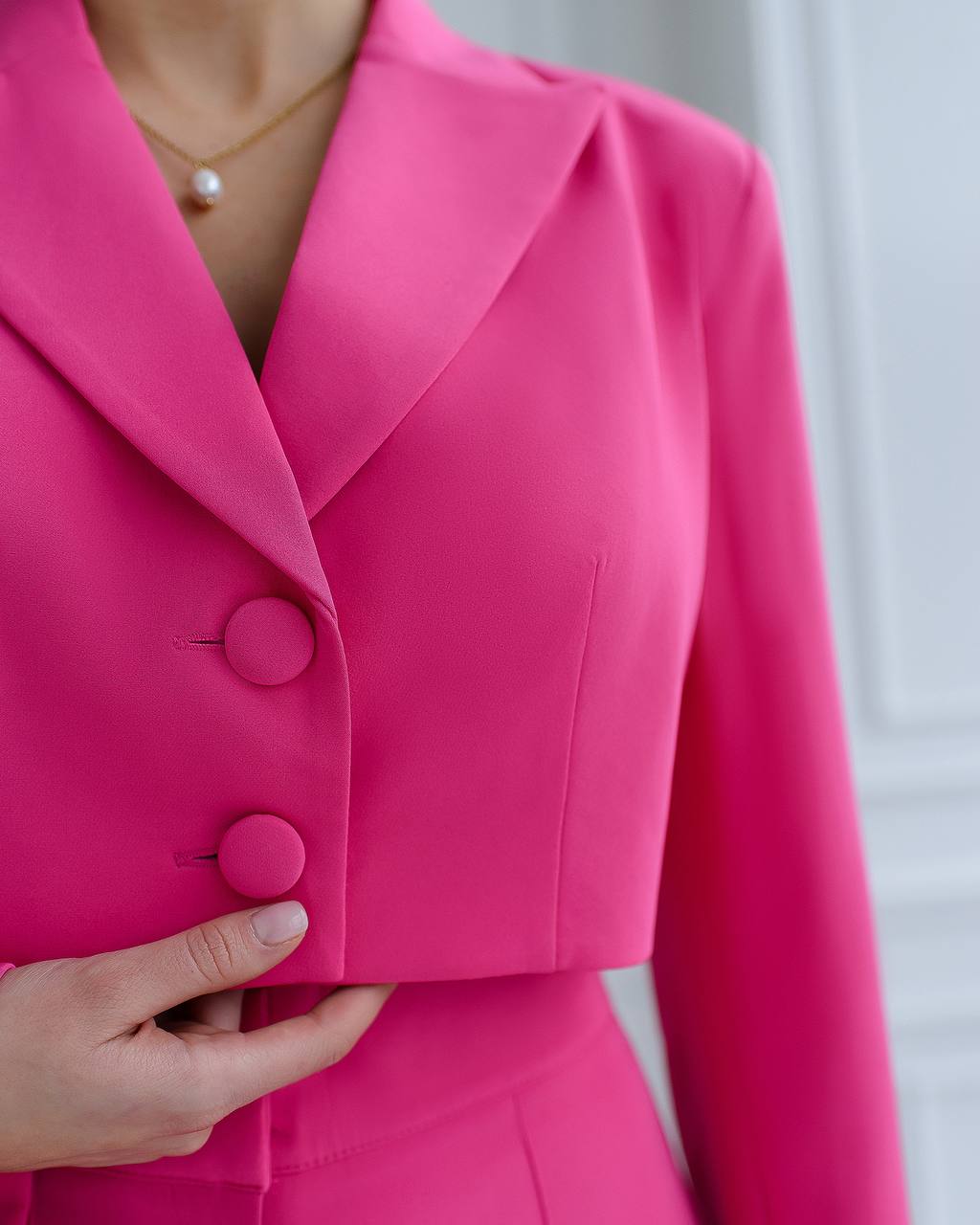 A crimson suit with a crop jacket and flared pants